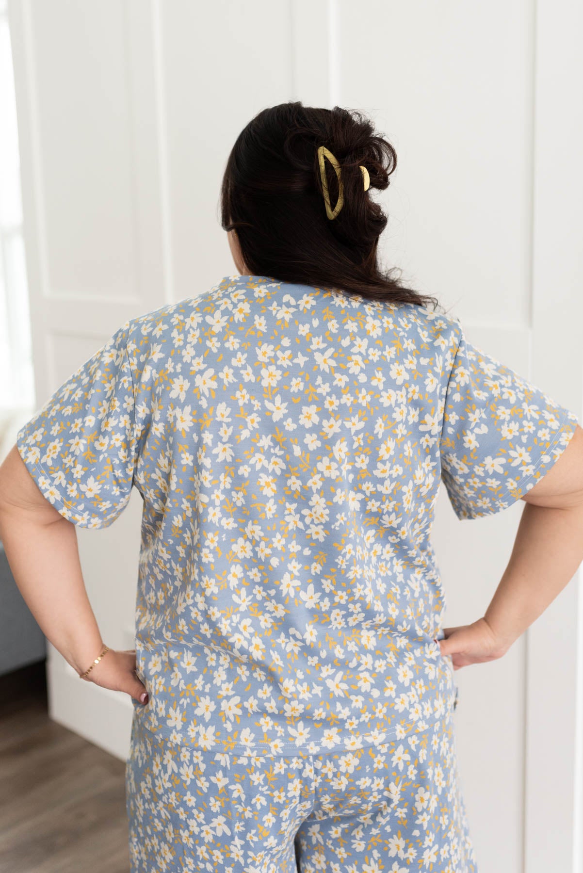 Back view of a plus size blue floral top