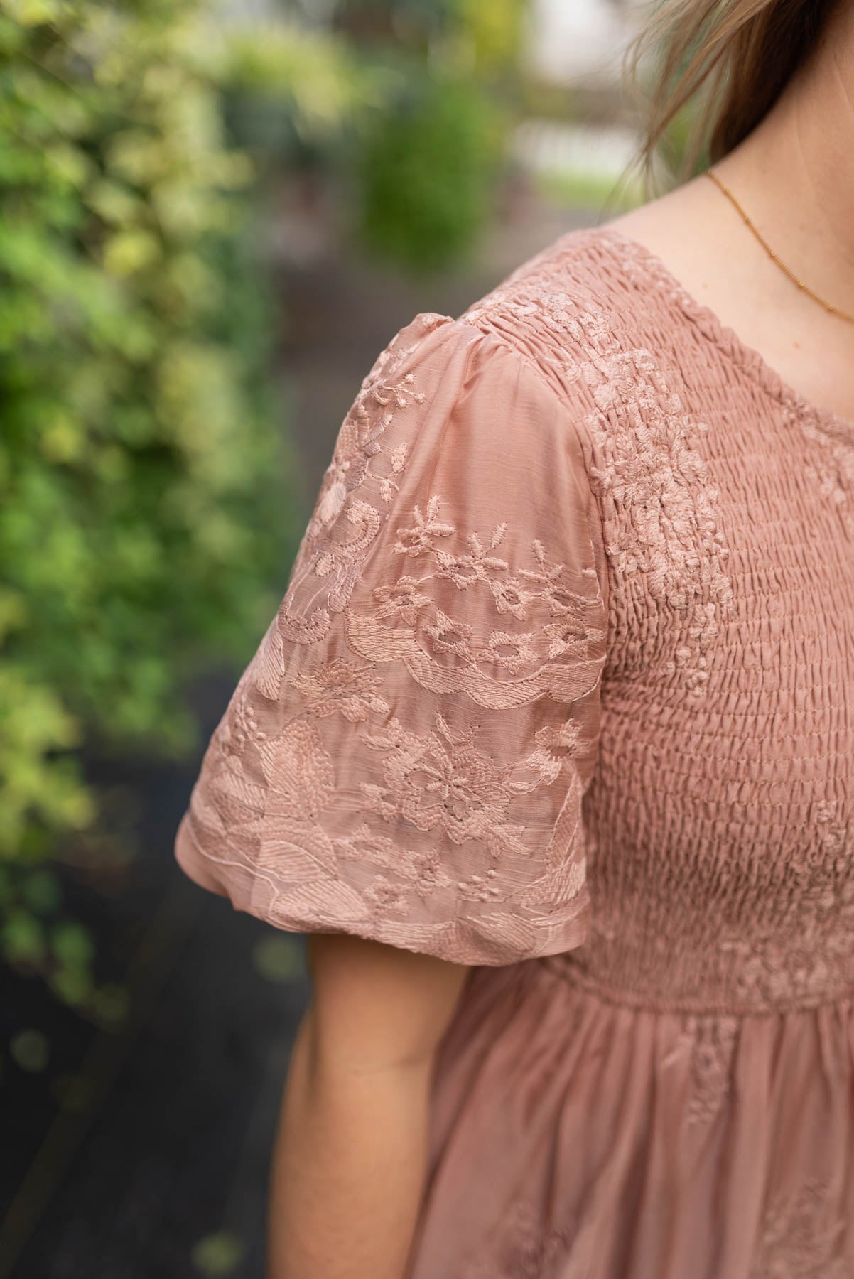 Close up of the sleeve on the dusty pink embroidered dress