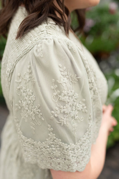 Close up of the embroidery on the plus size sage embroidered dress
