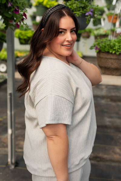 Side view of the plus size sage grey textured top