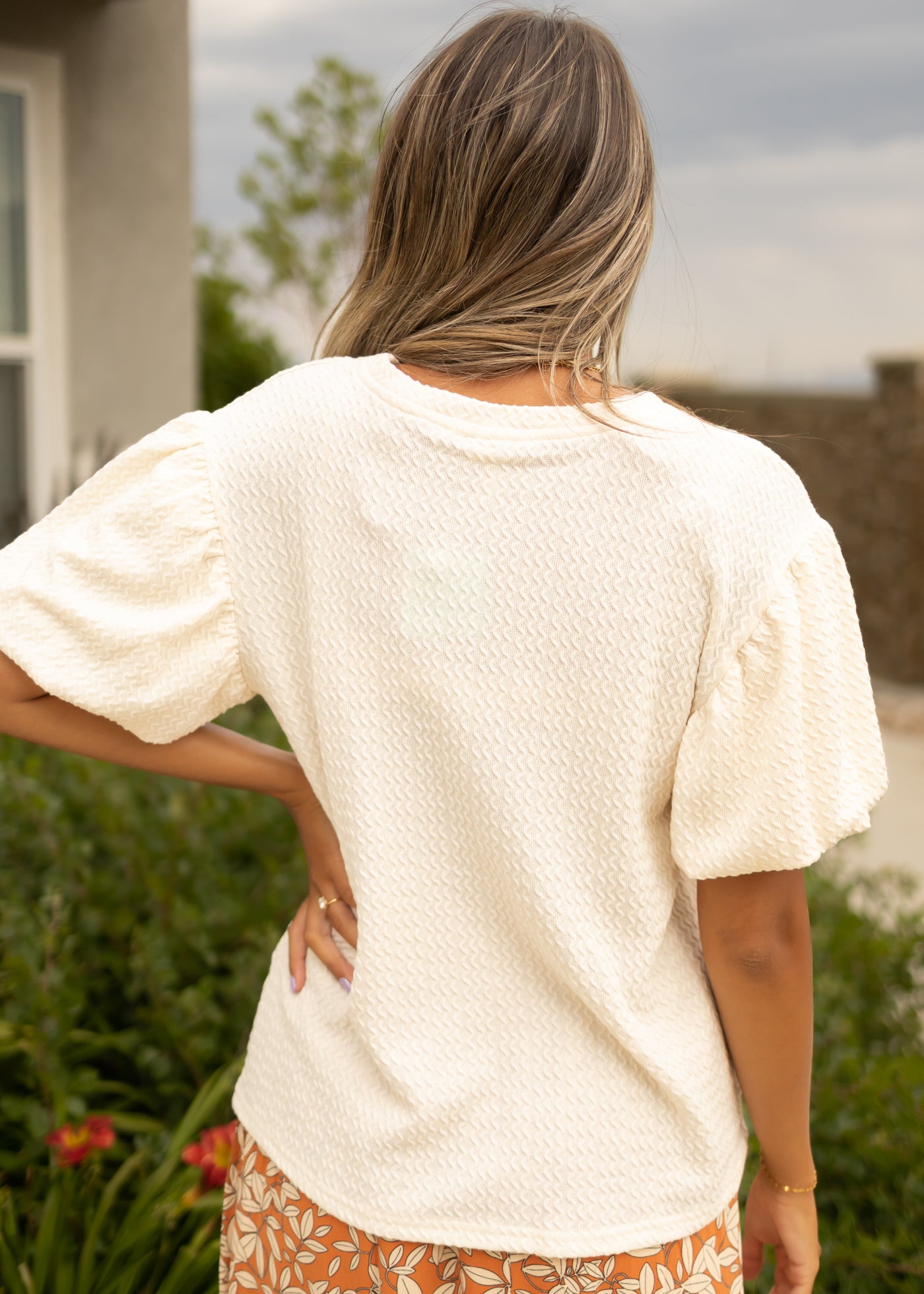 Back view of a cream textured top