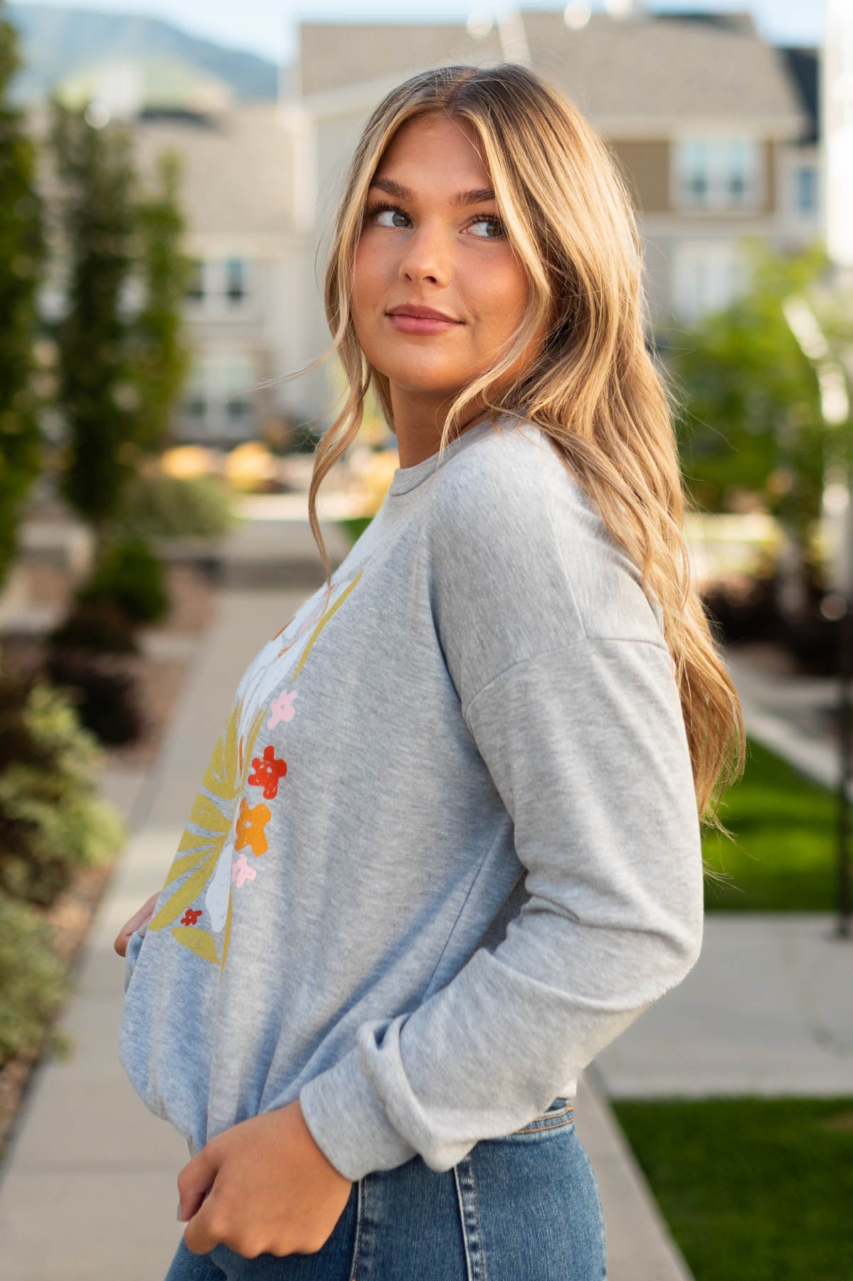 Side view of a heather grey pullover