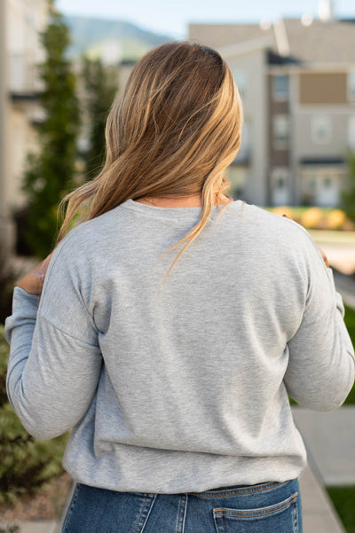 Back view of a heather grey pullover