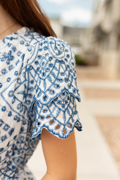 Close up of the tiered sleeve and fabric on the blue embroidered dress
