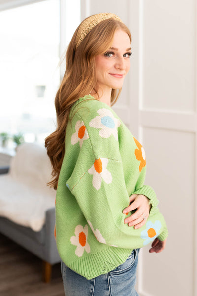 Side view of a green floral sweater