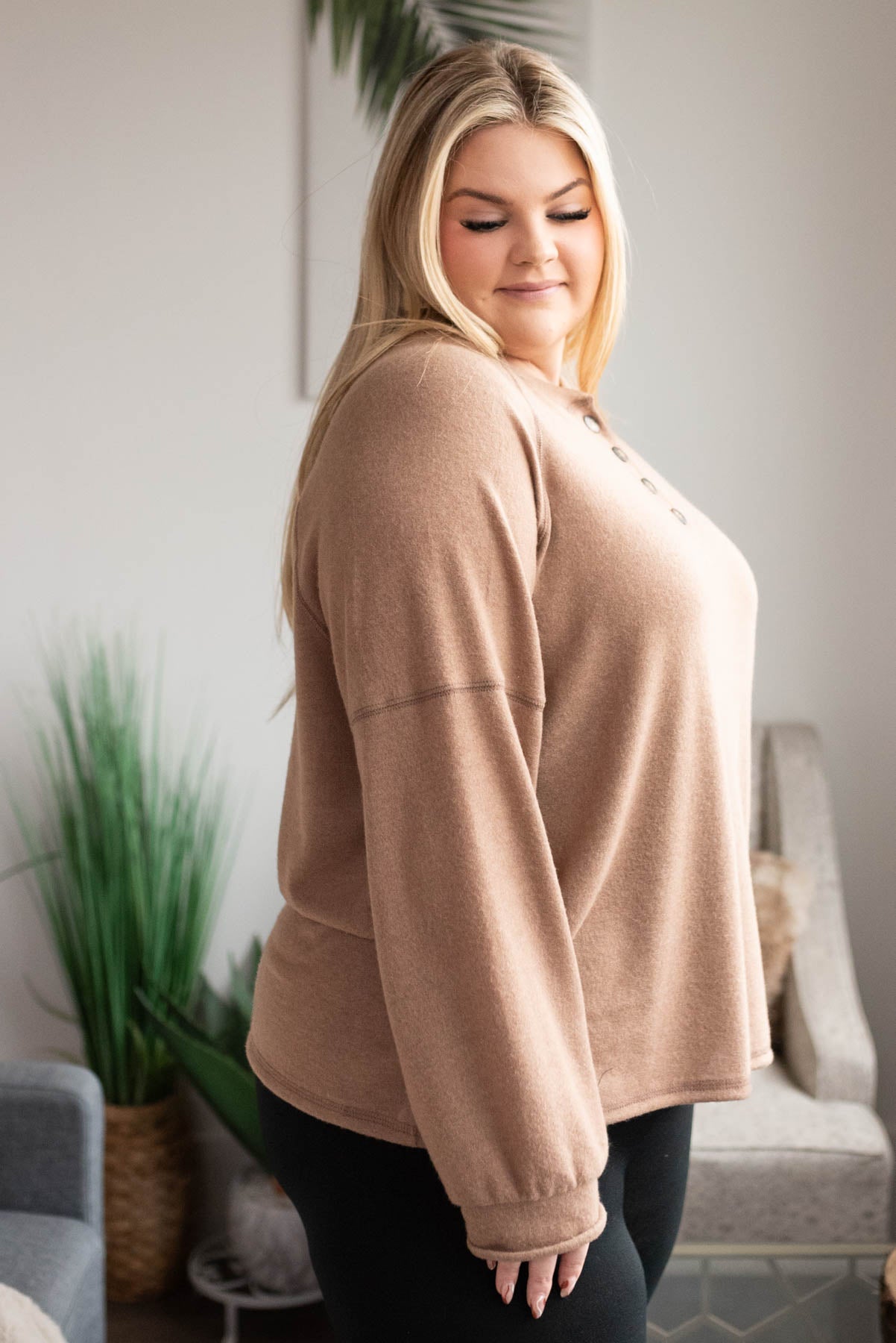 Side view of the plus size mocha button top