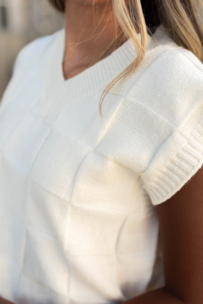 Pattern of a Ivory sweater vest