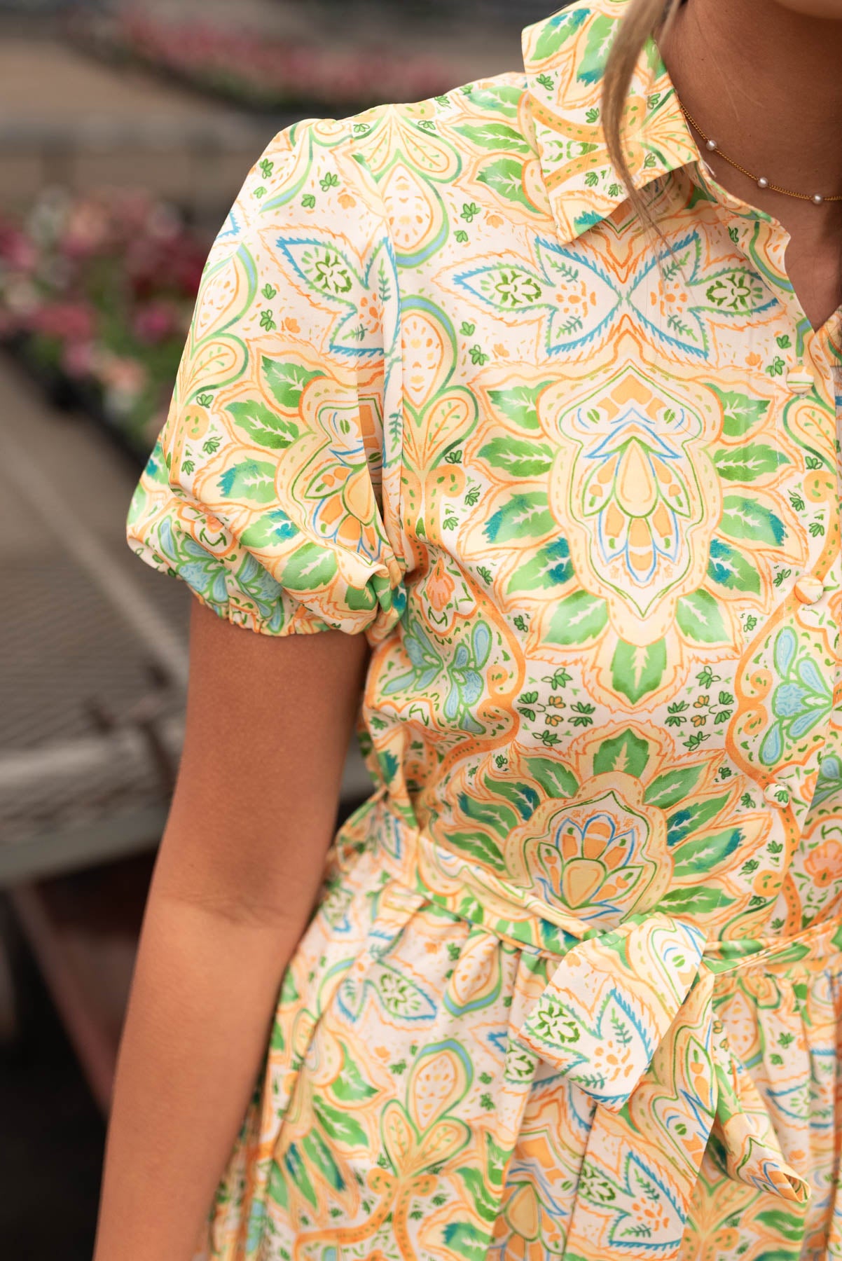 Close up of the pattern on the yellow green floral dress