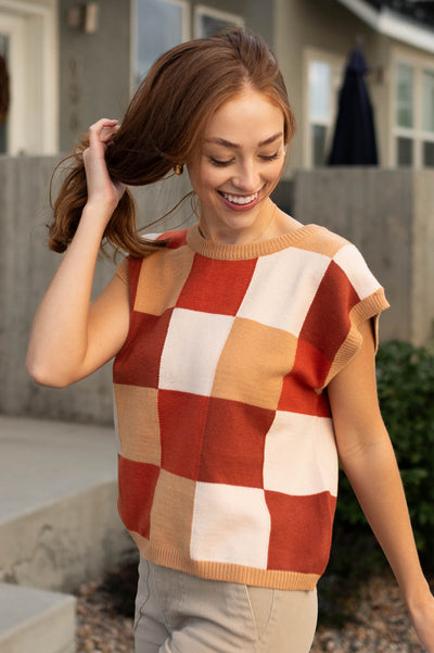 Side view of a checkered sweater vest