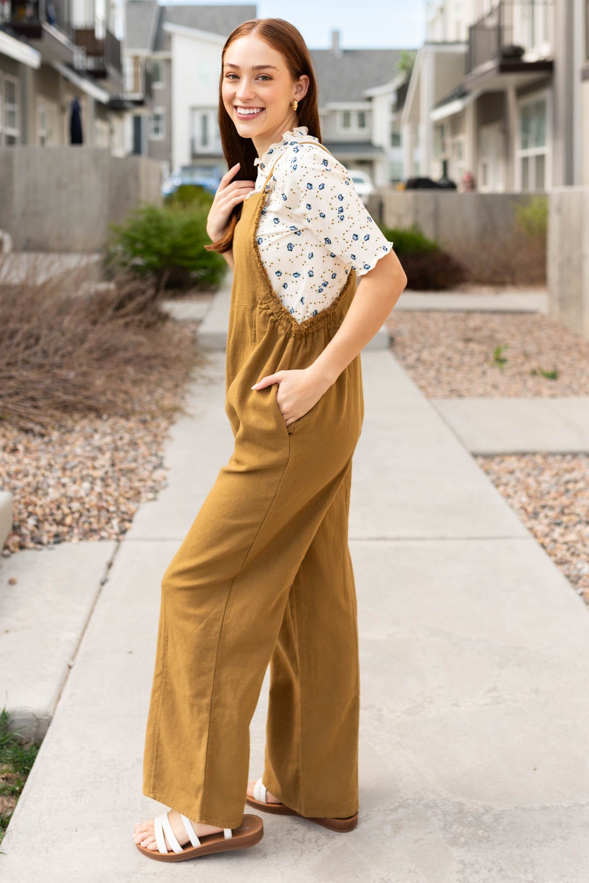 Side view of the dark mustard washed jumpsuit with pockets