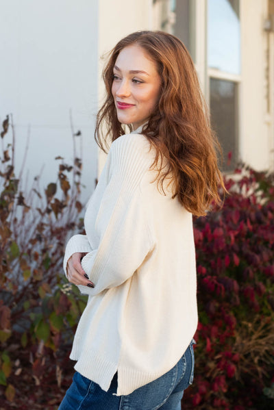 Side view of a ivory sweater