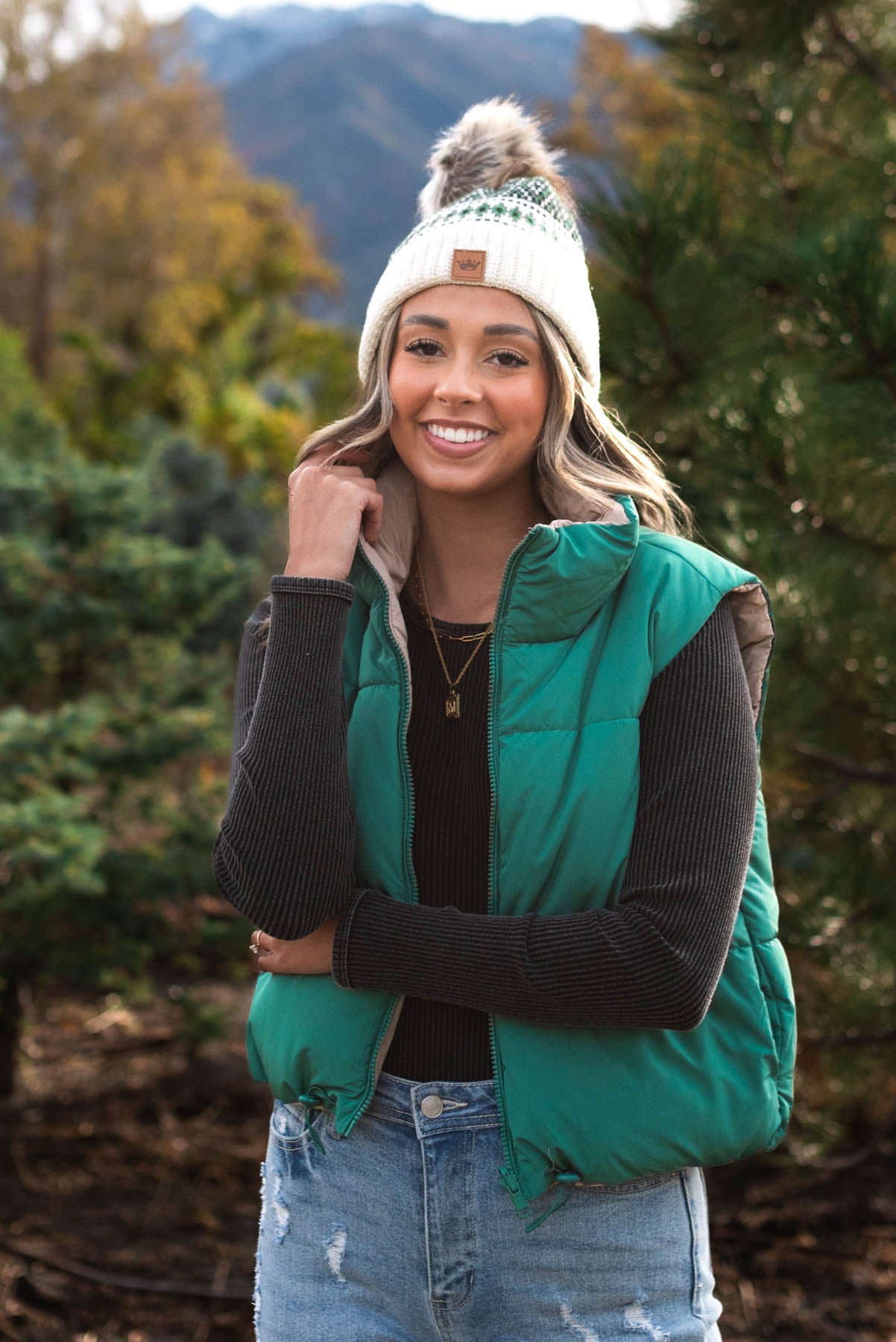 Front view of  a green reversible puff vest
