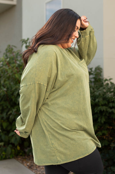 Side view of a plus size olive pullover