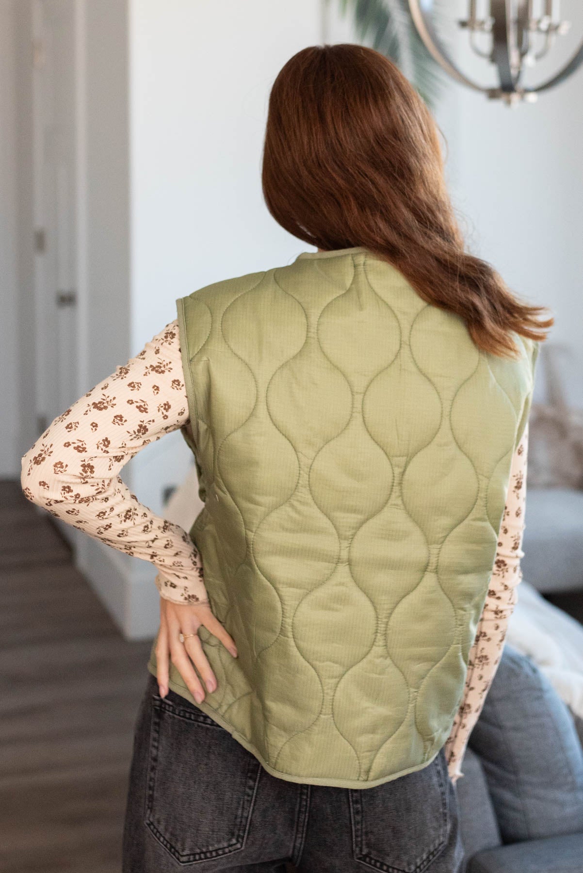 Back view of a olive quilted vest