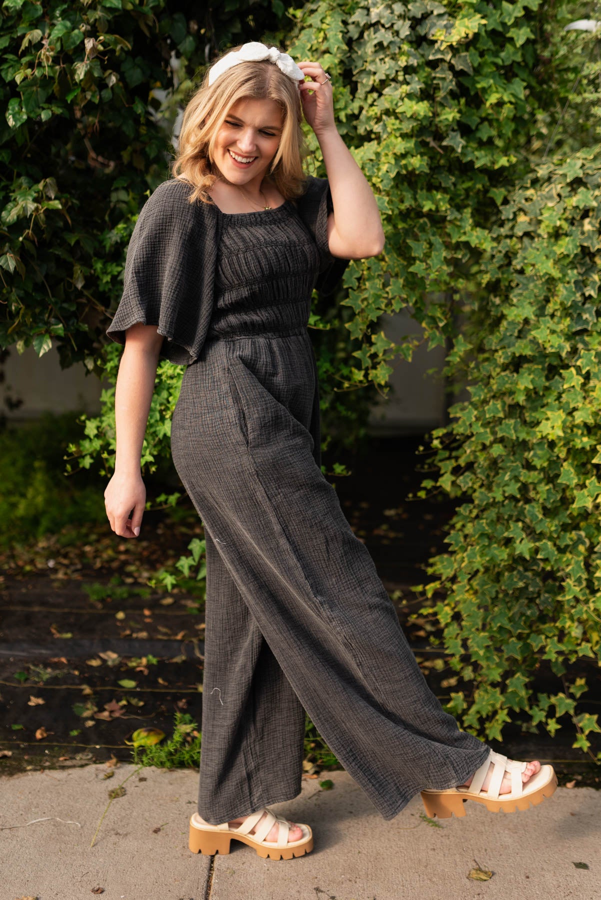 Side view of the charcoal wide leg jumpsuit with pockets