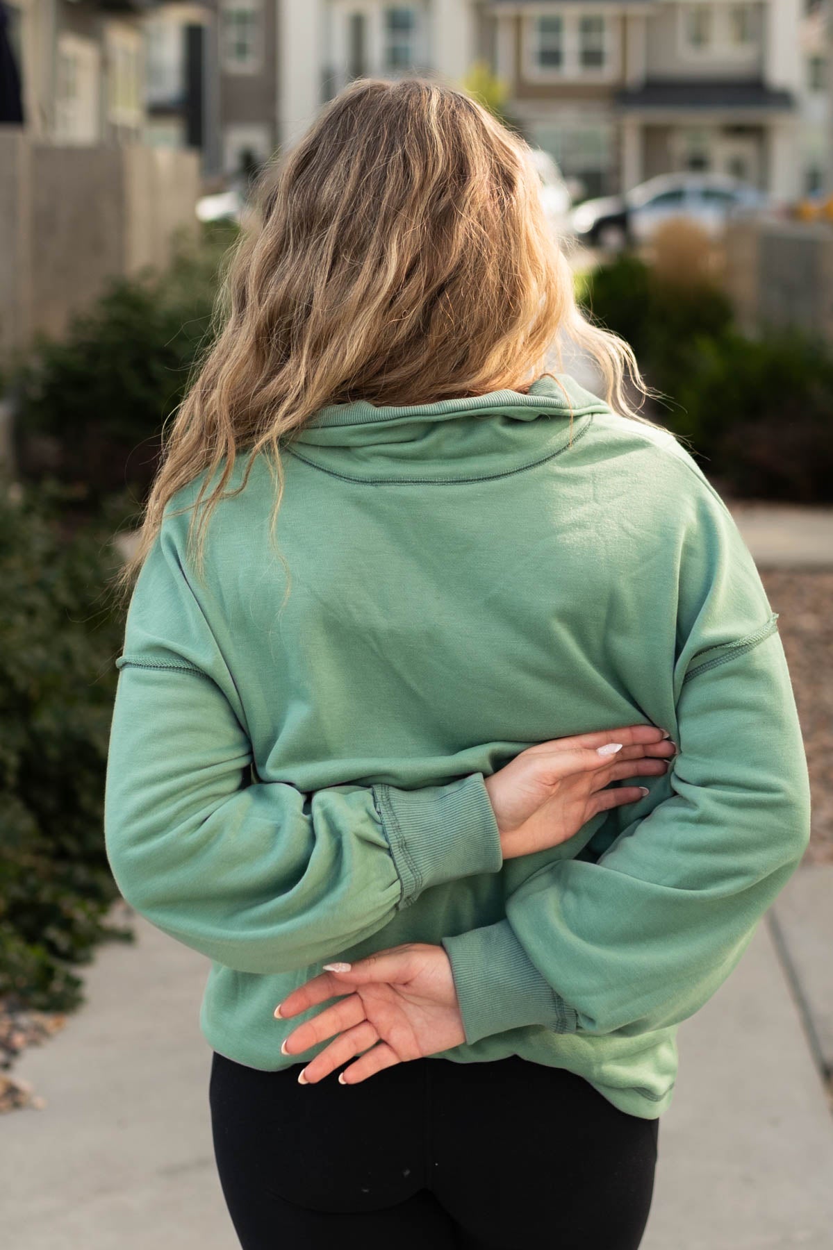 Back view of a dark sage pullover