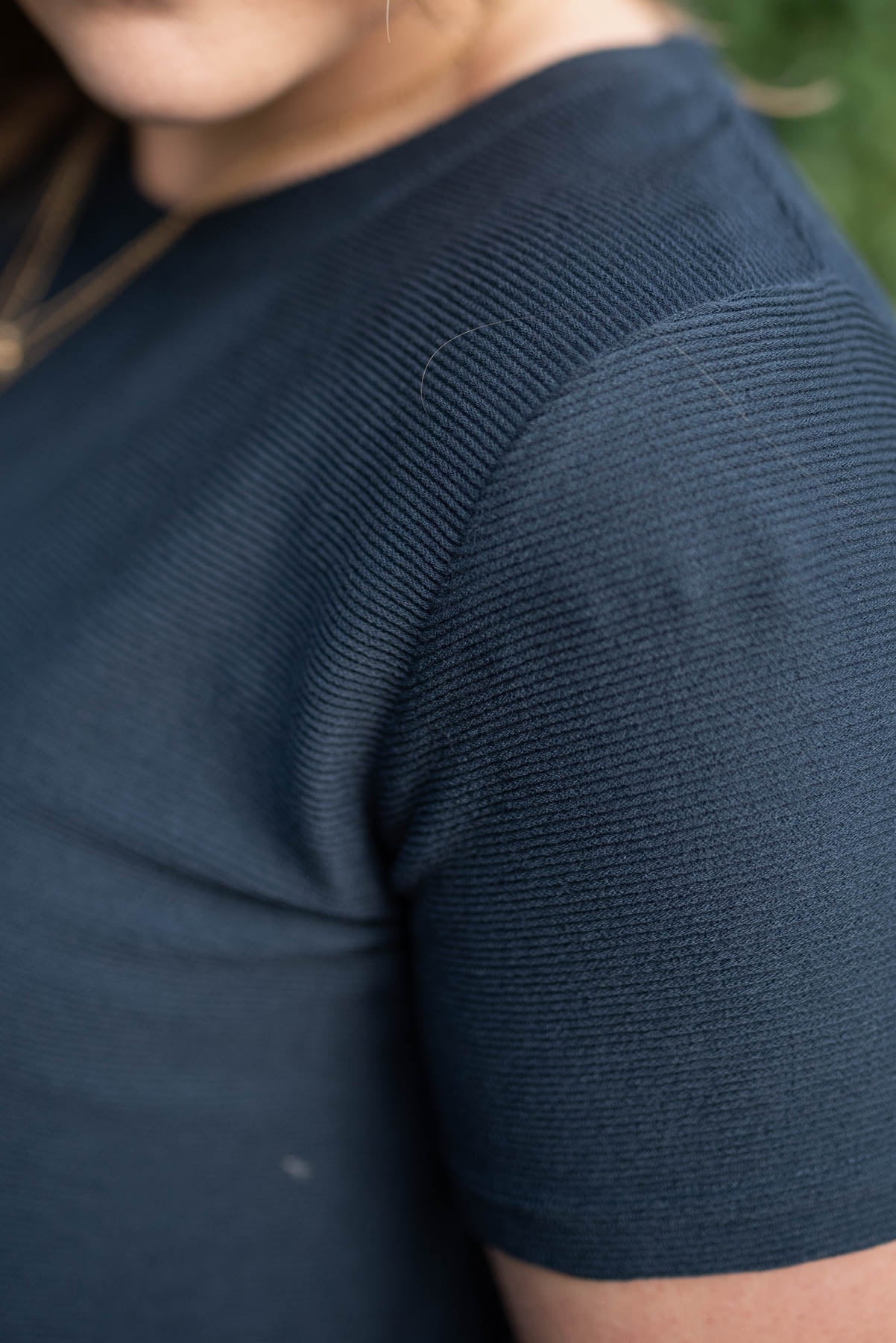 Close up of the sleeve on the navy textured top