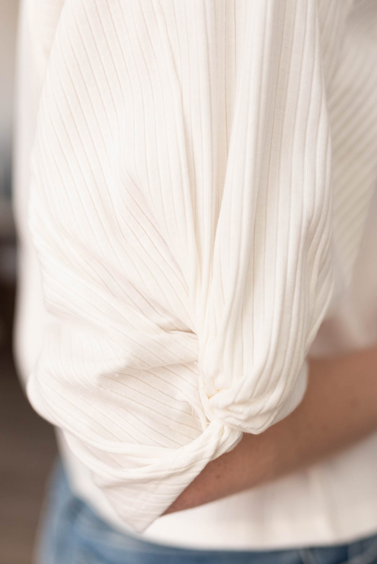 Close up of the sleeve on the white twist sleeve top