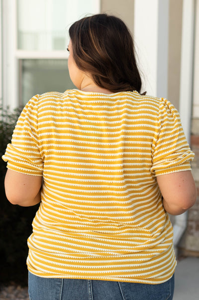 Back view of a plus size mustard top