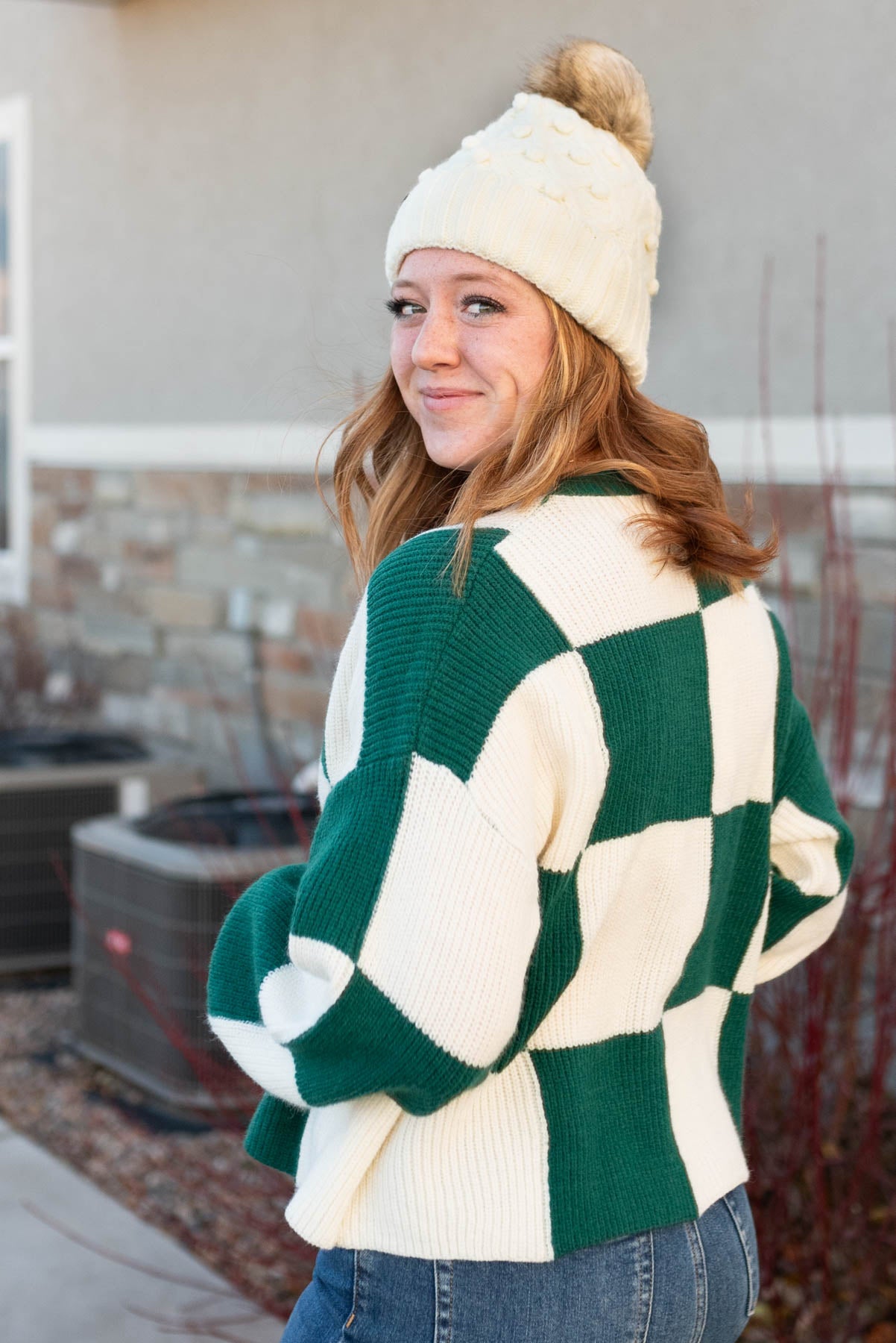 Side view of a hunter green sweater