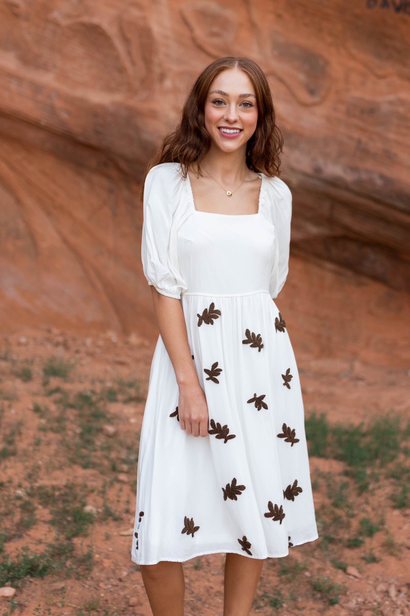 Short sleeve ivory dress with leaf pattern on the skirt