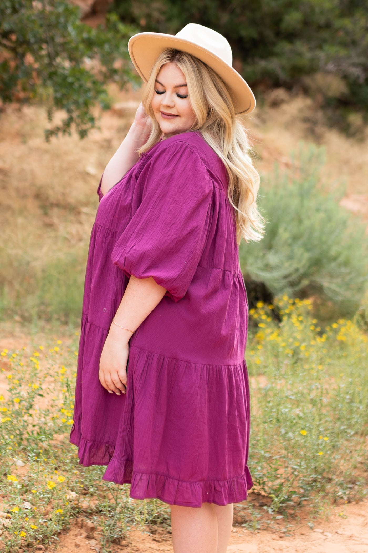 Side view of a plus size berry dress