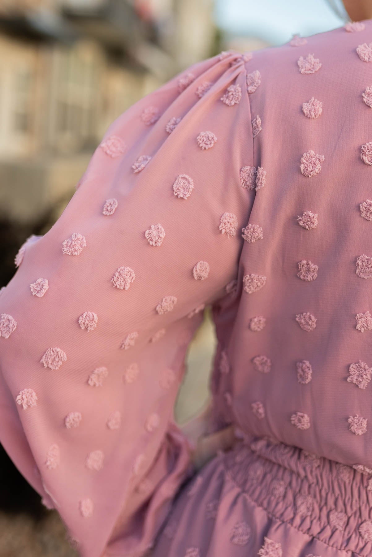 Close up view of the fabric on a plus size mauve dress