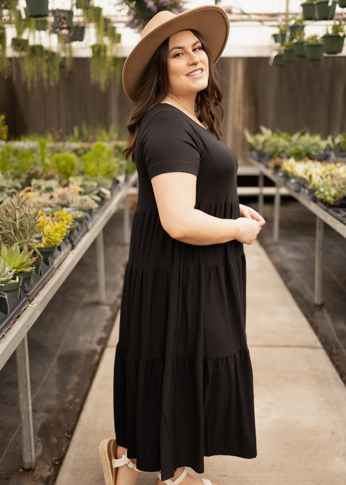 Side view of a plus size black tiered dress