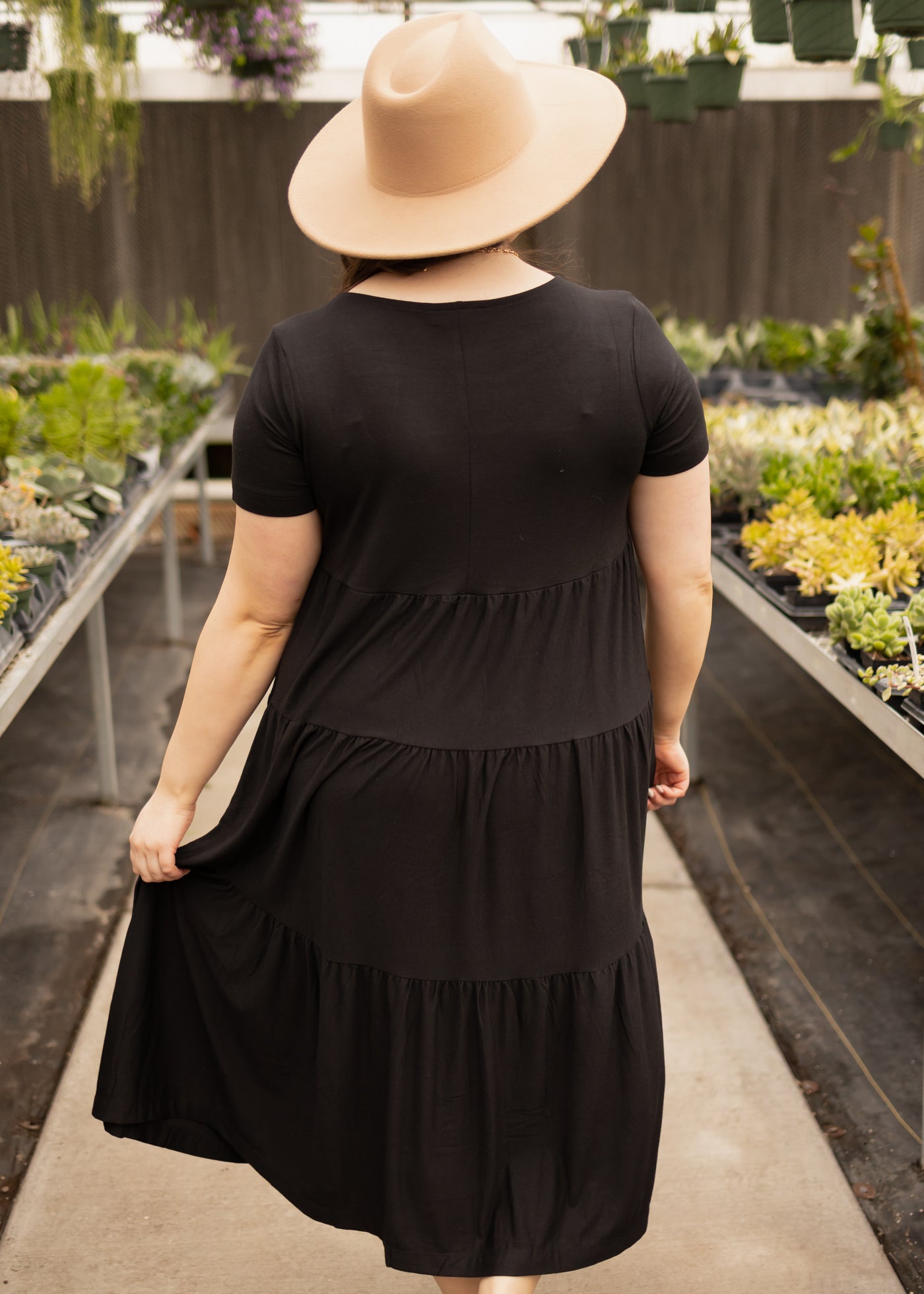 Back view of a short sleeve black tiered dress
