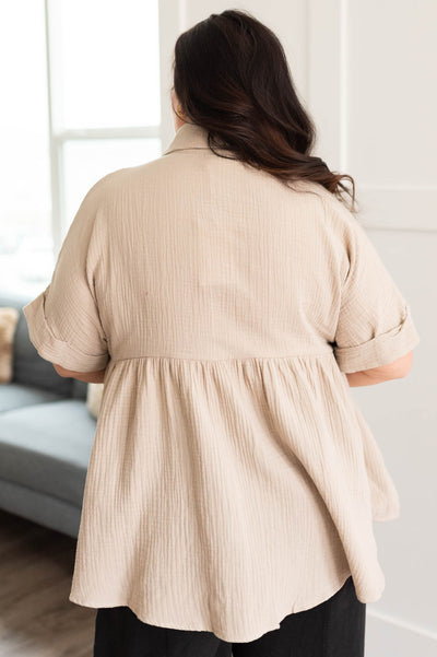 Back view of the plus size taupe button down top