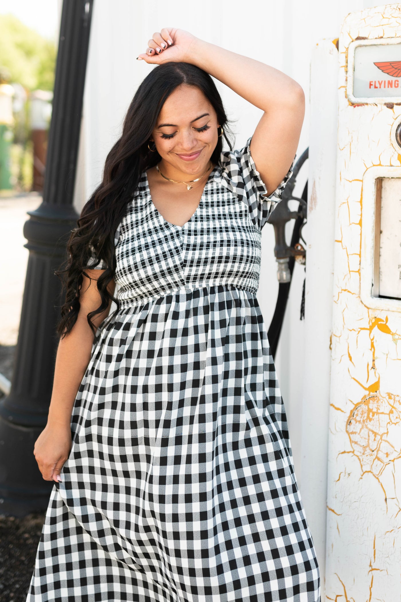 Plus size black gingham dress with short sleeves and smocked top.