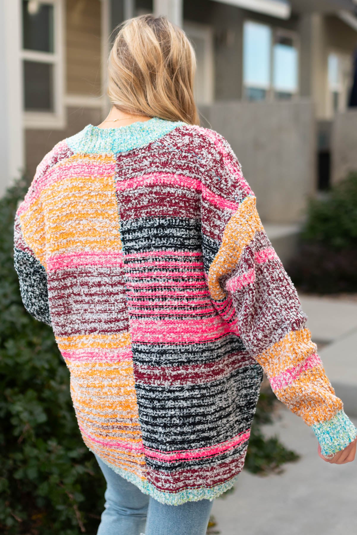 Back view of a multi knit open cardigan