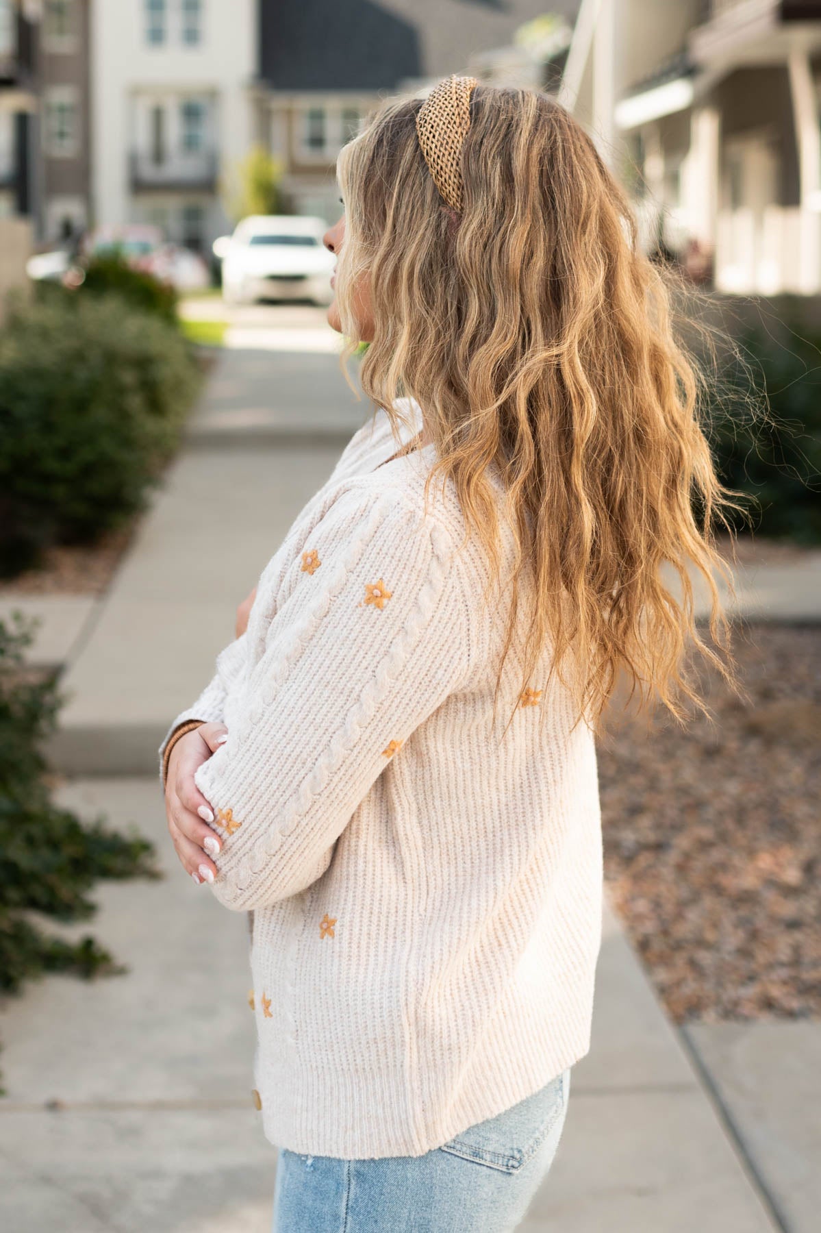 Side view of a small cream cardigan