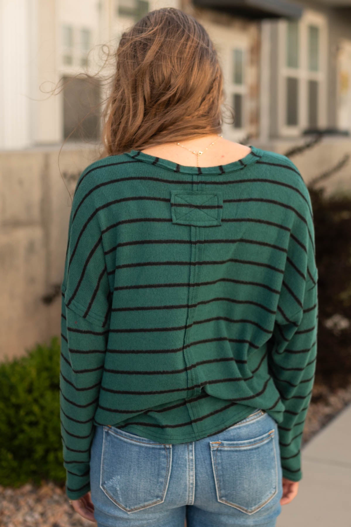 Back view of a hunter green top