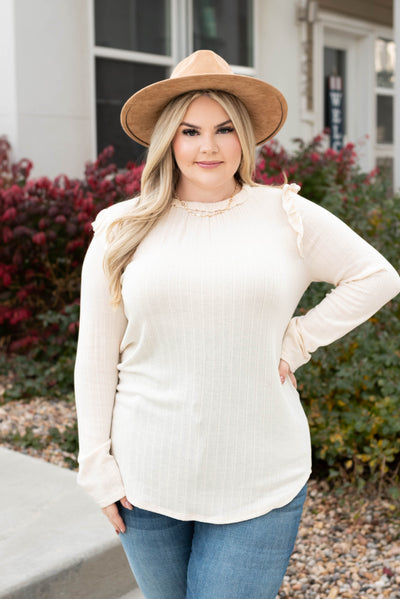 Front view of the cream ruffle long sleeve top