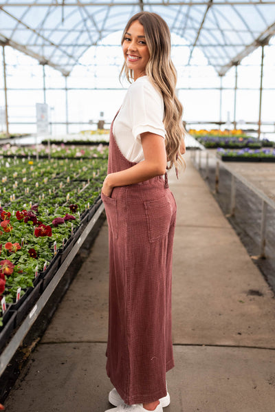 Side view of the faded plum washed overalls