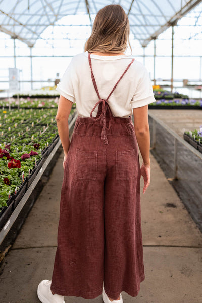 Back view of the faded plum washed overalls