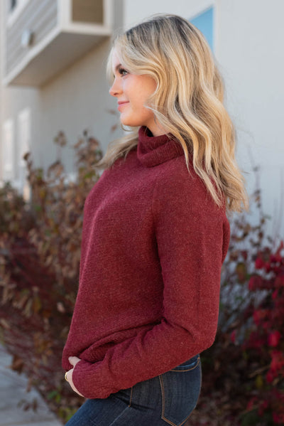 Side view of a burgundy sweater