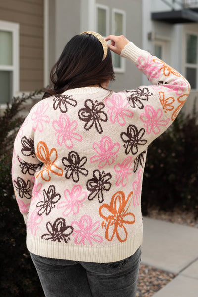 Back view of a plus size floral sweater