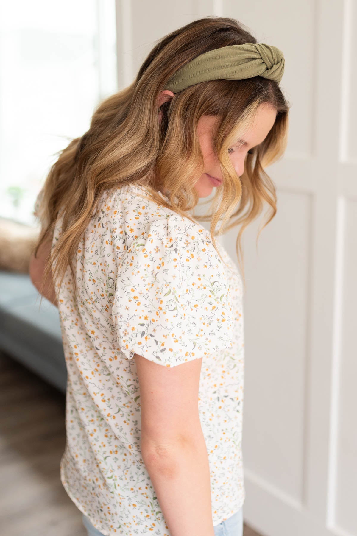Side view of the cream floral printed blouse