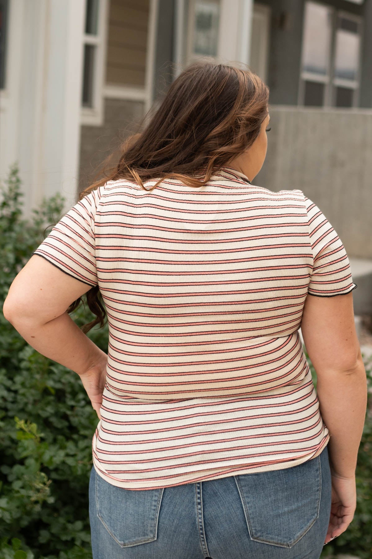 Back view of a plus size beige top
