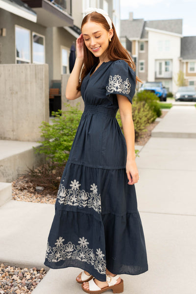 Side view of the navy embroidered detail dress