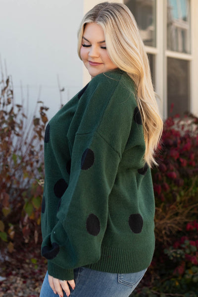 Side view of the plus size green poka dot sweater
