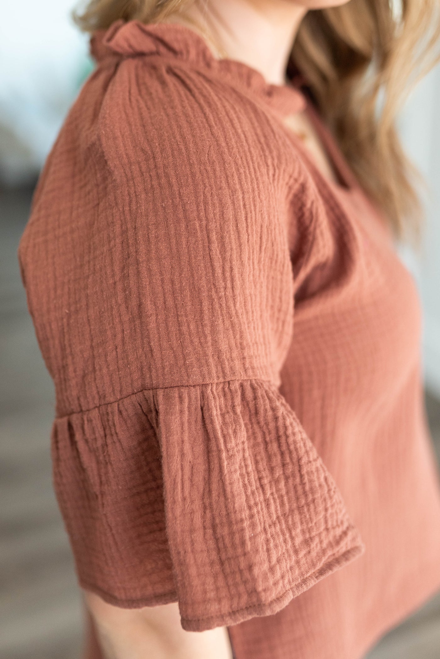 Close up of the sleeve on the terracotta blouse