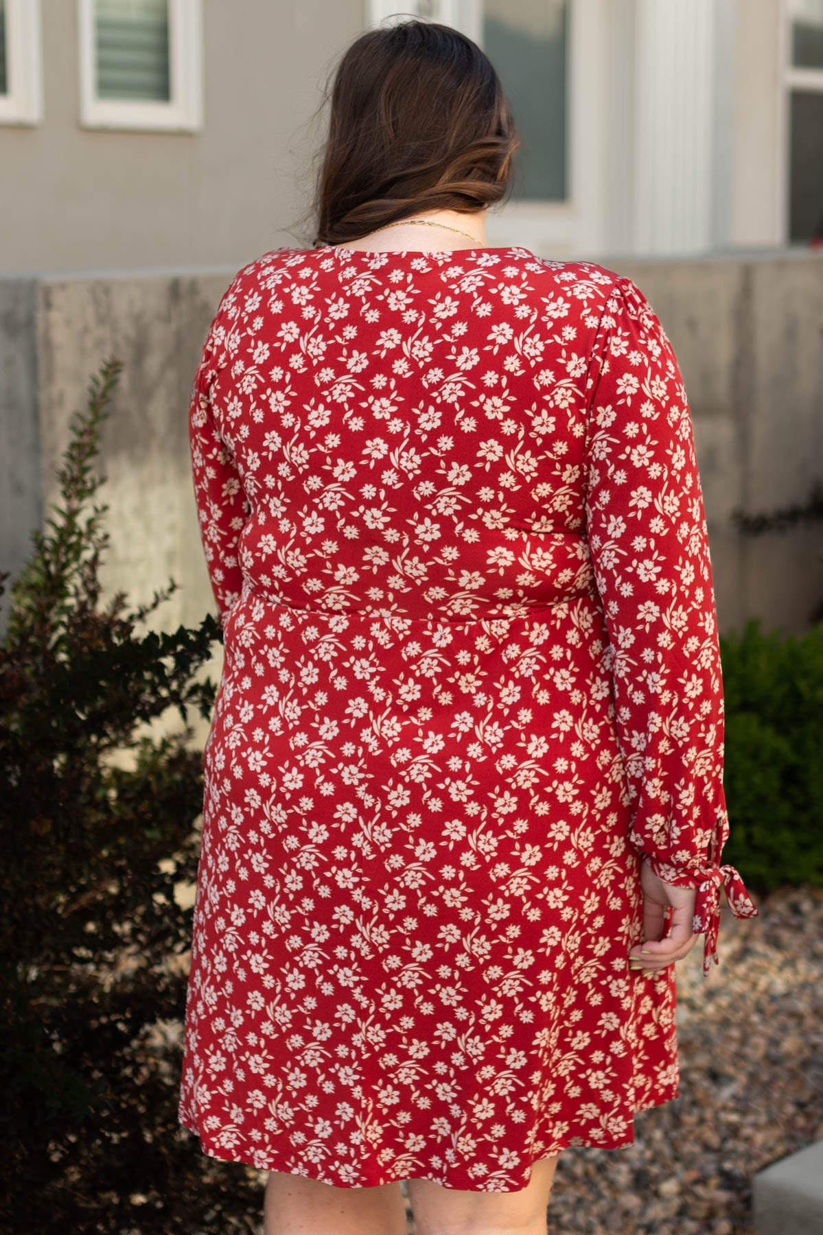 Back view of a plus size red floral dress