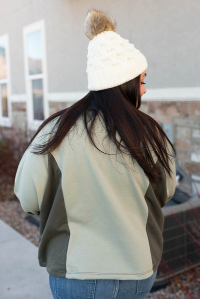 Back view of a plus size olive block sweater