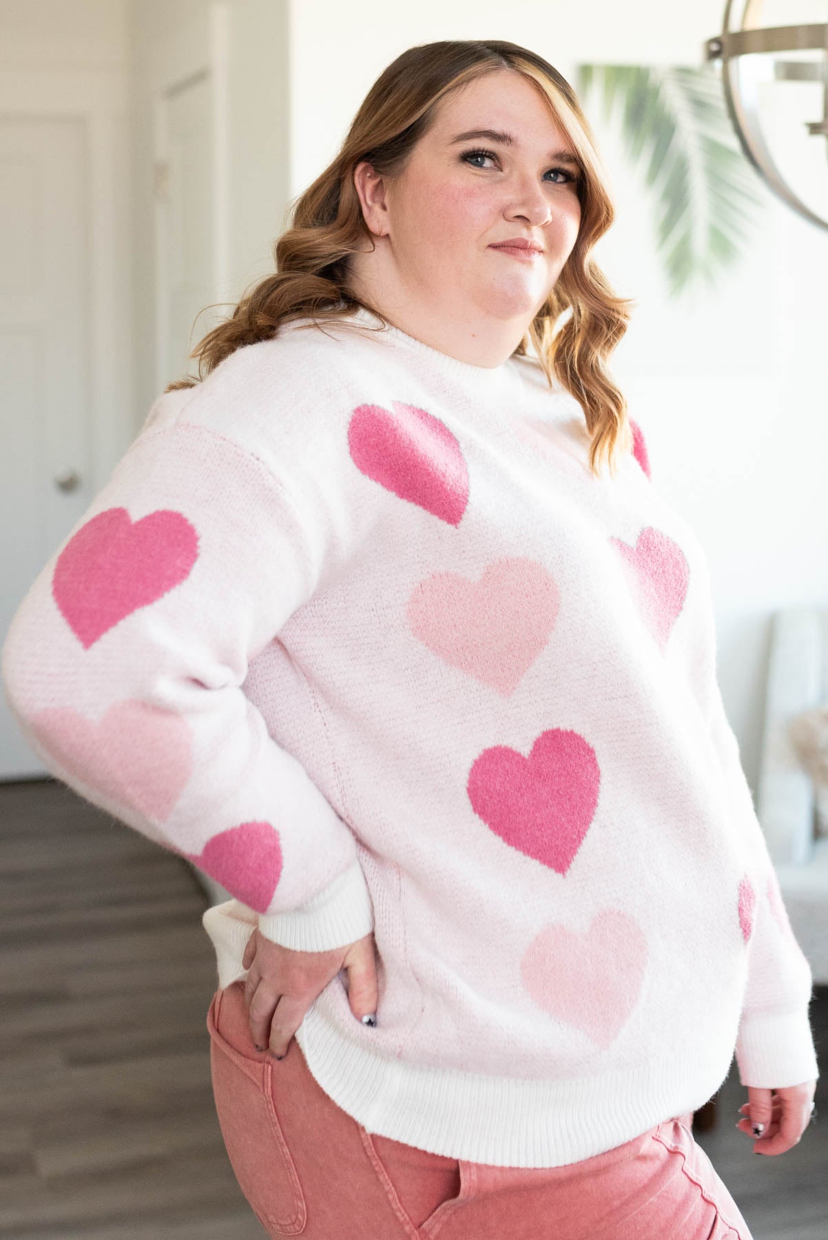 Side view of the plus size pink heart sweater