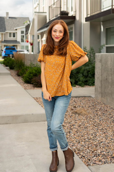 Mustard top with short sleeves and floral print