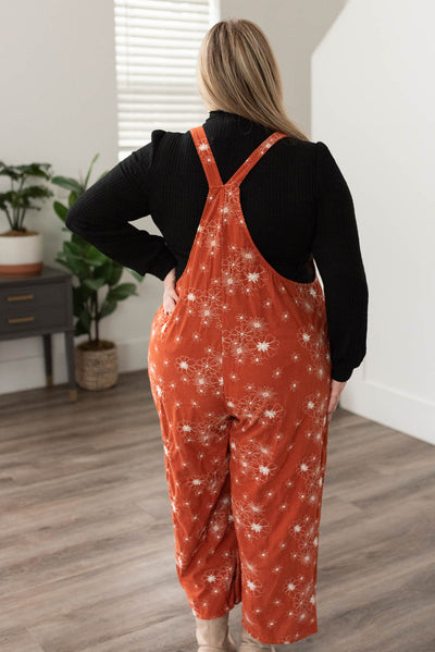 Back view of rust embroidered overalls