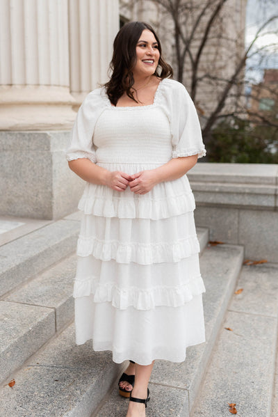 Front view of the plus size white tiered textured dress with short sleeves